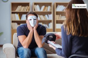 Man wearing a mask in therapy, symbolizing hidden truths and recognizing toxic relationship red flags.