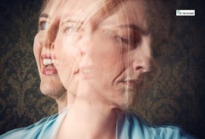 A blurred, double-exposure image of a woman showing multiple emotional expressions, including happiness and sadness, symbolizing mood and personality changes.