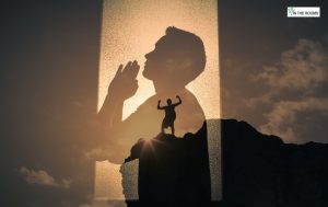 A silhouette of a person praying overlaid with another image of a person standing triumphantly on a mountain peak, symbolizing inner strength and spiritual awakening in recovery.